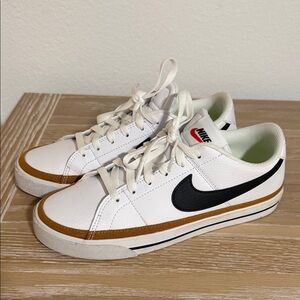 Nike White Sneakers with Black Swoosh and Gold Trim